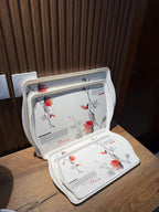 Takalluf hand-painted floral melamine trays, close-up of red and grey floral pattern